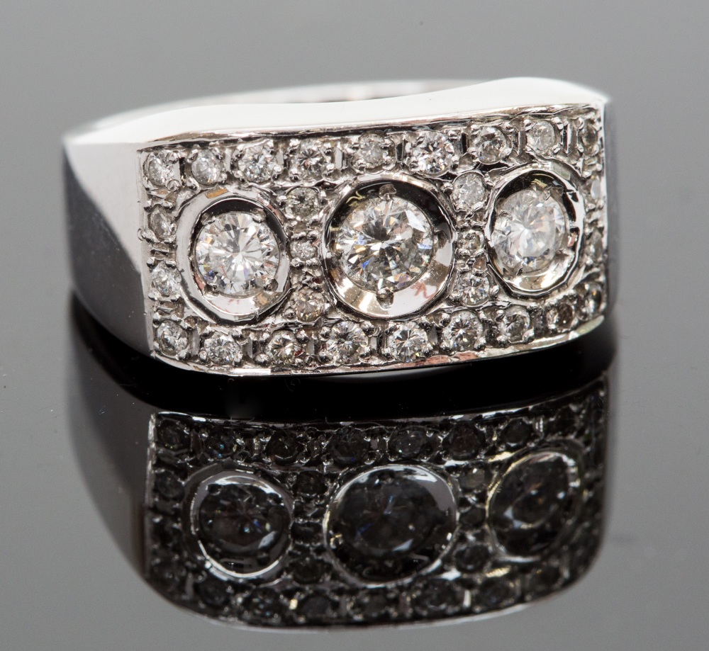 An 18ct white gold and diamond ring, set with three round brilliant-cut diamond, surrounded by