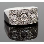 An 18ct white gold and diamond ring, set with three round brilliant-cut diamond, surrounded by