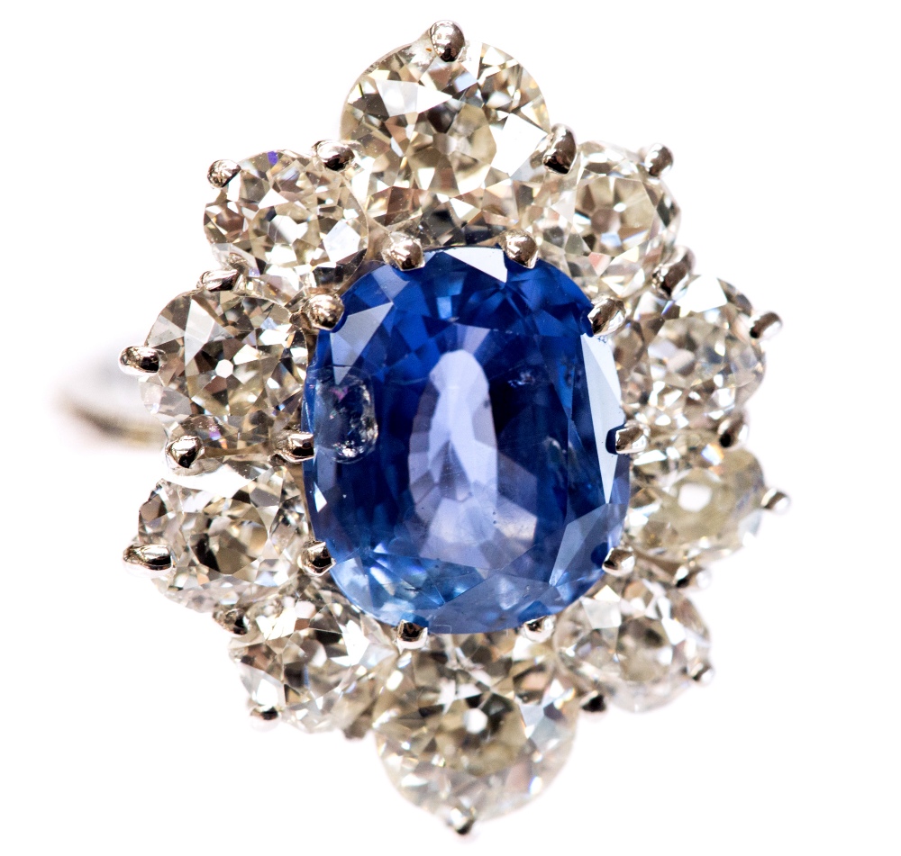 An 18ct white gold, sapphire and diamond cluster ring, the central oval-cut sapphire approx 4. - Image 3 of 3