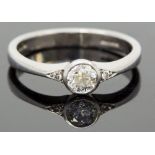 A platinum and diamond solitaire ring, the round cut brilliant stone approx 0.3ct, with two stones