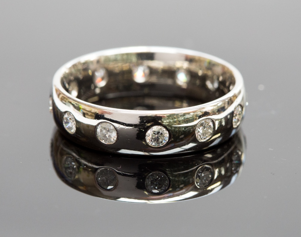 A platinum and diamond eternity ring, set with twelve round-brilliant cut diamonds, approx 1.