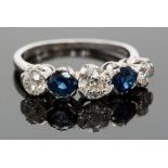 A platinum, sapphire and diamond five-stone ring, set with three diamonds divided by two sapphires,