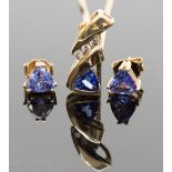 A tanzanite and diamond pendant, set with a triangular cut tanzanite below a row of three round