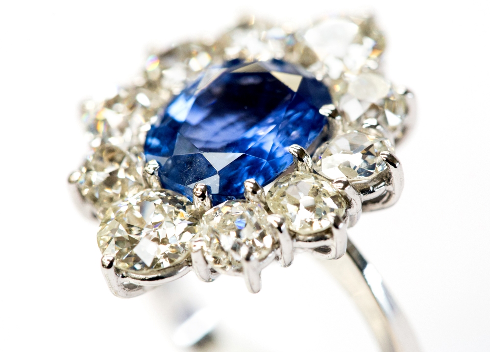 An 18ct white gold, sapphire and diamond cluster ring, the central oval-cut sapphire approx 4. - Image 2 of 3