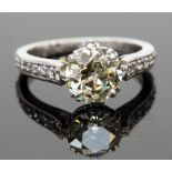 A platinum and diamond solitaire ring, the central stone approx 1.75cts, flanked by diamond set