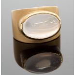 A continental 18k gold and moonstone ring, the cabachon stone collet set in high relief, brushed