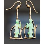 A pair of gold and jade earrings, the jade carved as Oriental ladies, in a wire frame, tested as