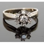 A 14k white gold and diamond cluster, the central round brilliant-cut stone approx 0.20ct,