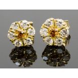 A pair of diamond cluster earrings, the centre fancy yellow stones surrounded by six white diamonds,