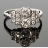 An Art Deco style diamond ring, millegrain set with two round cut stones, flanked by fourteen