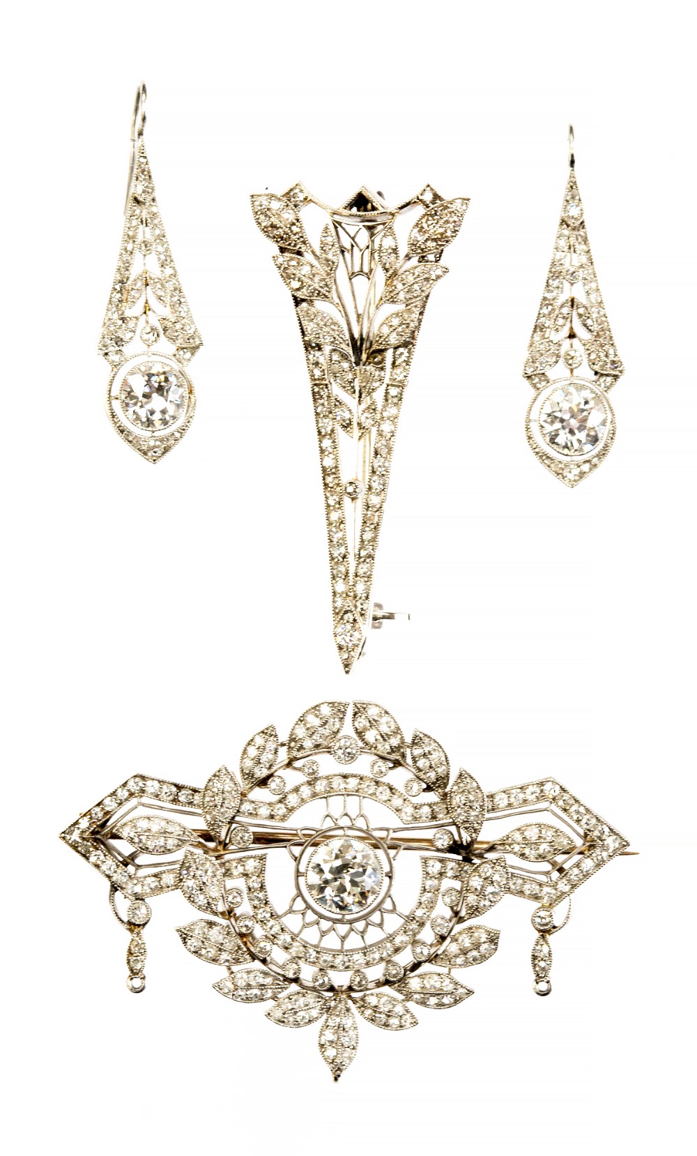 A Belle Epoque platinum and diamond brooch, of leaf and geometric form, the central stone approx