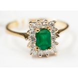 An 18ct emerald and diamond cluster ring