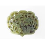 A carved jade plaque, reticulated floral design in a lobed cartouche, 5cm wide