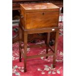 A George III mahogany tea caddy on stand, the tea caddy top inlaid with paterae to centre