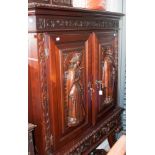 A Romanesque style modern side cabinet, fitted with two doors over two drawers, the doors with