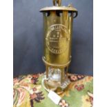A late 19th/early 20th Century brass miners lamp, stamped projector lamp and lighting Eccles, 24 cm
