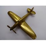 A brass Spitfire with moveable propeller, Art Deco shape