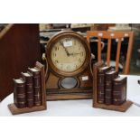 A rhythm mantel clock, with a Westmister chime, quartz movement, together with a pair of book ends,