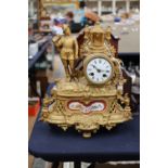 A 19th century French Mantle Clock gilt metal with enamelled dial and porcelain plaque.