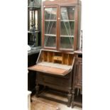 A 1920s oak bureau bookcase