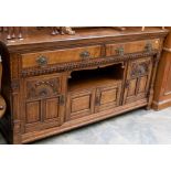 A late Victorian oak sideboard in the aesthetic style, fitted with four panelled doors, pot shelf