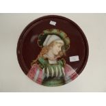 An Austrian cabinet plate, hand finished depicting a young lady in 19th Century dress on a deep red