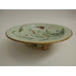 A Minton serving dish, raised on base with classical feet pads, celadon ground with hand coloured