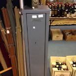 A three gun steel cabinet fitted with two locks,
