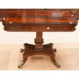 An early 19th century mahogany card table, the folding top raised on a square sectioned pedestal,