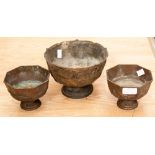 Three bronzed metal Chinese style bowls, pedestal form cast with dragons, on hardwood bases (3)