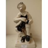 A Breton style pottery figurine of a shoe maker, similar to early Quimper figures from late 19th to