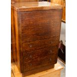 An Art Deco oak sewing cabinet, the hinged lid opening to reveal storage section and fitted with