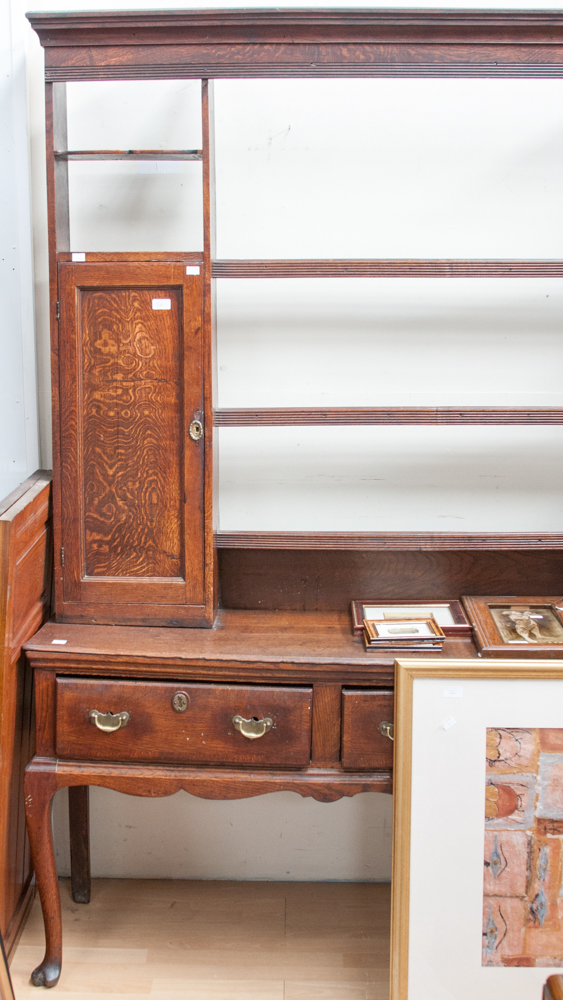 A George II oak dresser and rack, the rack with two cupboard sections and three plate racks, the