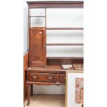 A George II oak dresser and rack, the rack with two cupboard sections and three plate racks, the