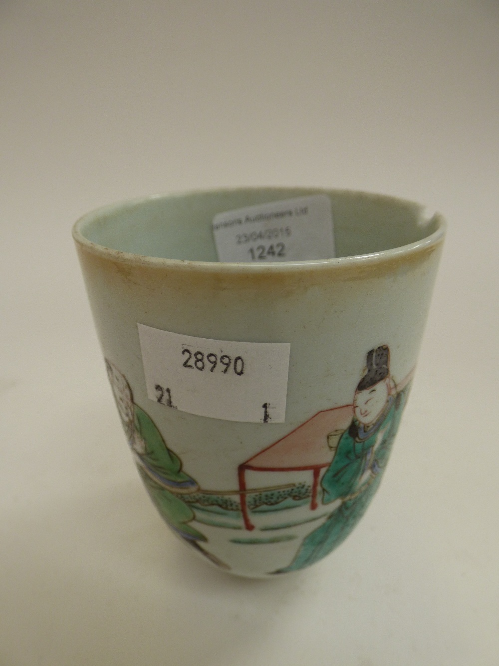 An oriental porcelain beaker of cylindrical form, chipped or cracked,