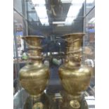 A pair of Oriental brass vases