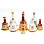 A collection of Bells whisky decanters including Diana,