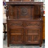 A Jacobean style oak court cupboard with a cupboard section to upper part, fitted with two drawers