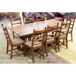 A traditional oak dining table and a matching set of eight chairs of ladder back form (9)