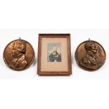 A pair of cast metal portrait plaques of Wellington and Napoleon in profile, topgether with a