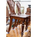 A pair of Victorian style mahogany and stained hall chairs