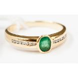 An emerald and diamond ring