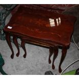 A late 20th century nest of three tables, the tops inset with marquetry,