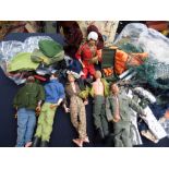 A box of Action Men with assorted clothes, etc