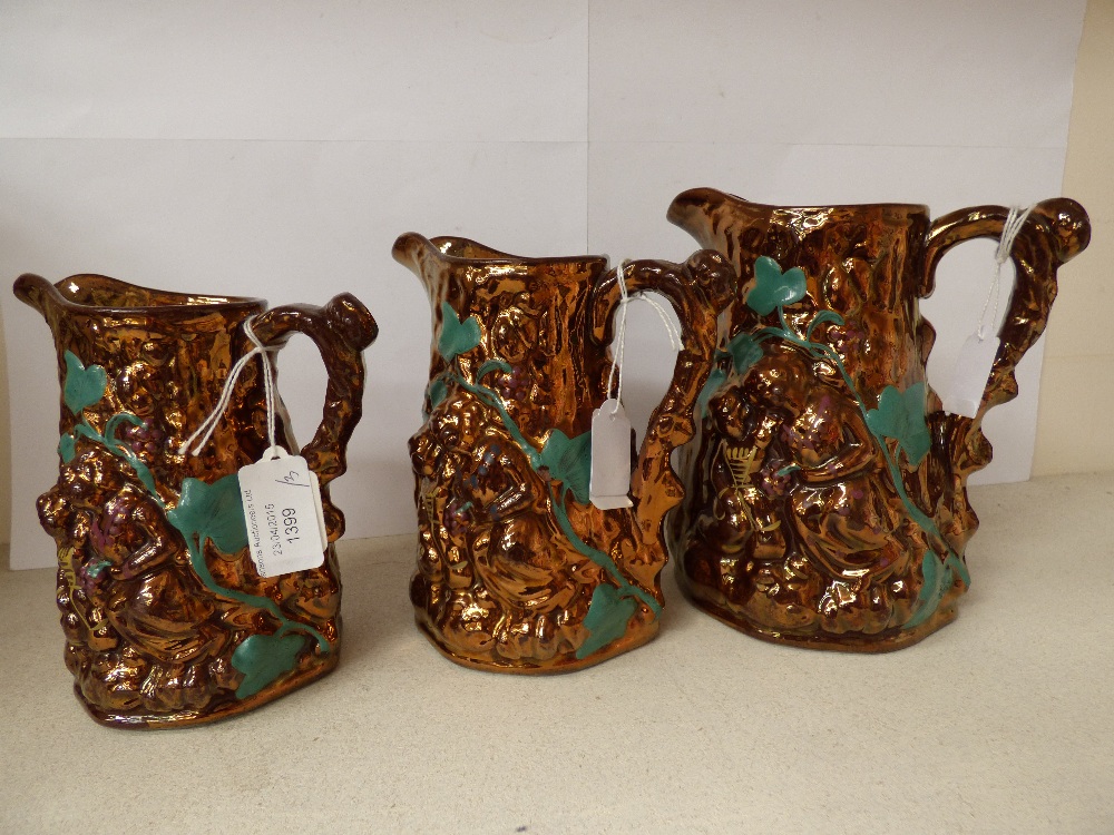 Three moulded copper lustre jugs