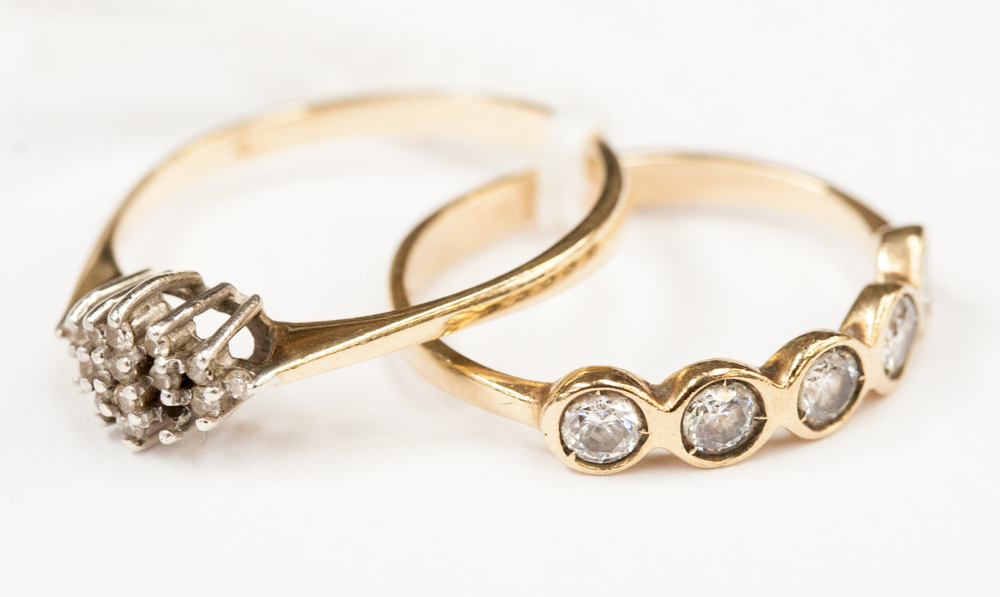 A diamond cluster ring on 9ct gold band; together with a five stone ring (2)