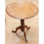 A mid 19th century oak and fruitwood tilt-top tripod table