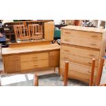 A 1970s oak bedroom suite, comprising six drawer chest, dressing chest and a double wardrobe (3)