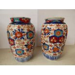 A pair of early 19th Century Japanese vases, painted in the Imari palette