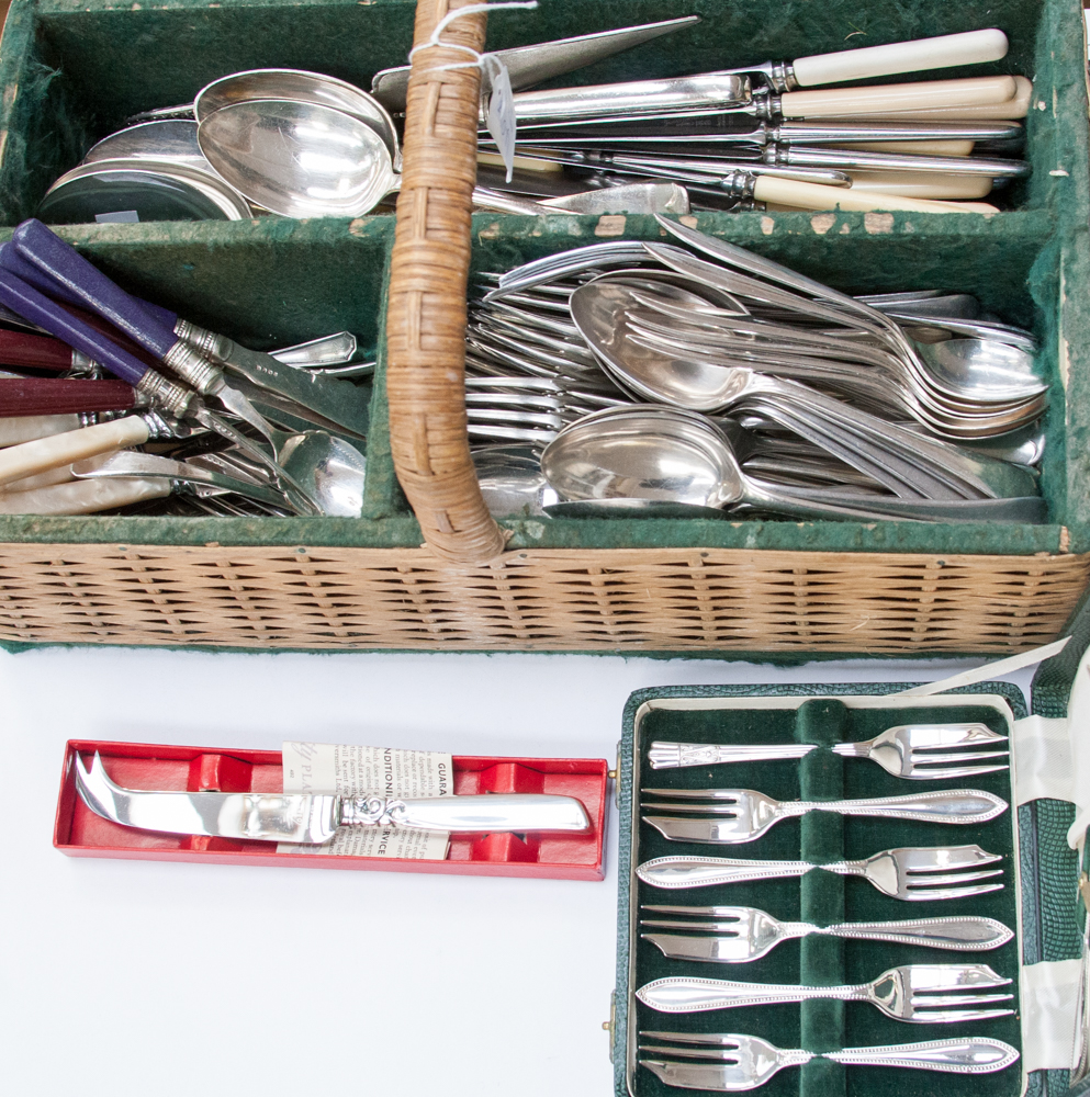 A basket of flatware and six cased cake forks with serving fork